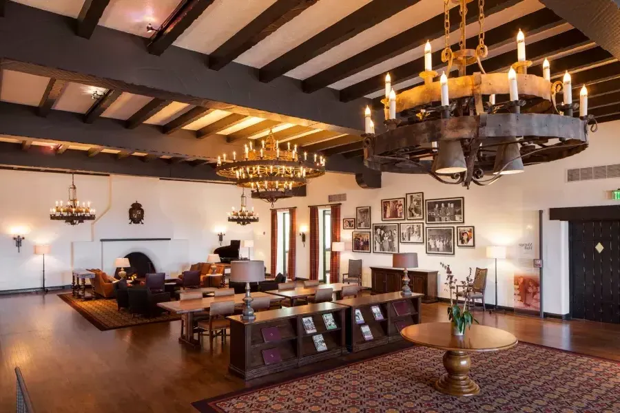 Interior of the historic Presidio Officers' Club, with wood-beam ceilings and large chandeliers.